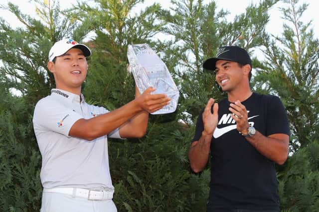 Last year's winner Jason Day, right, presented the winner's trophy to Si Woo Kim of South Korea after the final round of The Players Championship. Picture: Warren Little/Getty Images