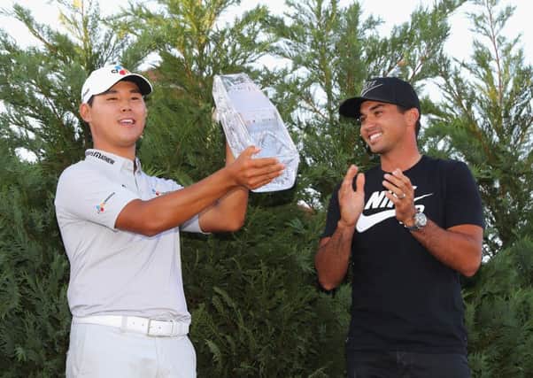 Last year's winner Jason Day, right, presented the winner's trophy to Si Woo Kim of South Korea after the final round of The Players Championship. Picture: Warren Little/Getty Images