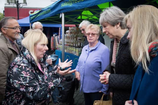 Prime Minister Theresa May meets Cathy Mohan at Abingdon market in Oxfordshire. Picture: PA