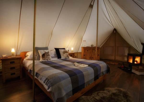 The canvas cottages at Dundas Castle have king-sized beds and log-burning stoves