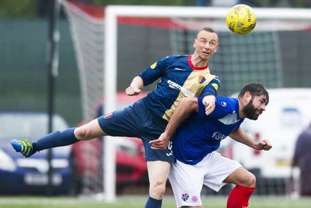 East Kilbride's David Proctor, left, battles with Cowdenbeath's Kris Renton during the first leg of the Pyramid play-off final at K-Park. Picture: SNS