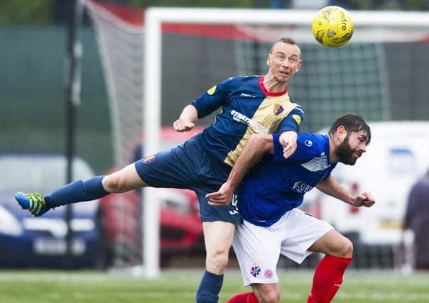 East Kilbride's David Proctor, left, battles with Cowdenbeath's Kris Renton during the first leg of the Pyramid play-off final at K-Park. Picture: SNS