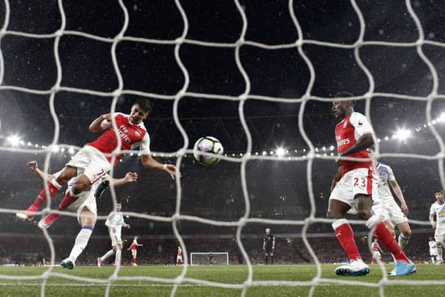 Alexis Sanchez heads Arsenals second goal in their victory over Sunderland. Picture: AFP/Getty.