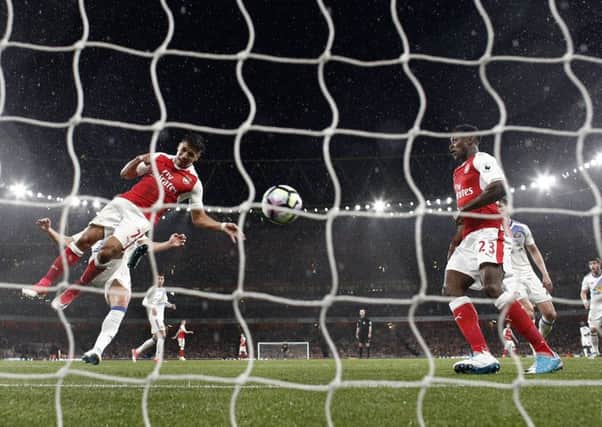 Alexis Sanchez heads Arsenals second goal in their victory over Sunderland. Picture: AFP/Getty.
