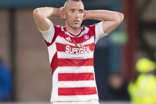 Hamilton's Darian MacKinnon stands dejected after Ross County's late winner. Picture: Bill Murray/SNS