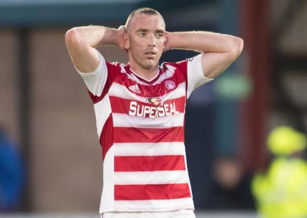 Hamilton's Darian MacKinnon stands dejected after Ross County's late winner. Picture: Bill Murray/SNS