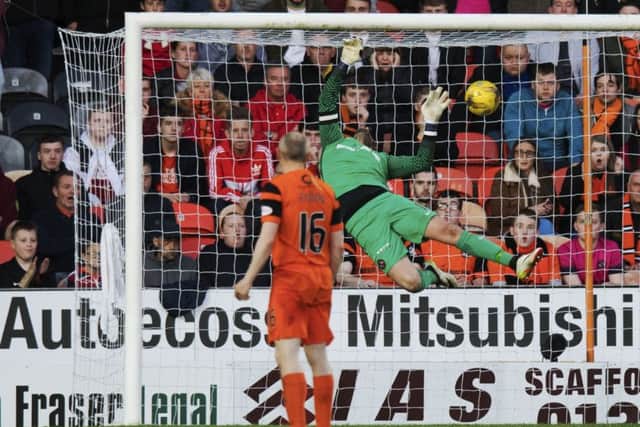 Willo Flood looks on as Joe McKees free-kick beats Dundee United goalkeeper Cammy Bell. Picture: SNS