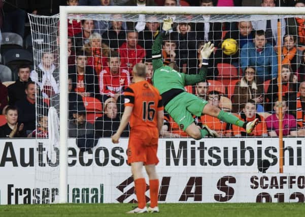 Willo Flood looks on as Joe McKees free-kick beats Dundee United goalkeeper Cammy Bell. Picture: SNS