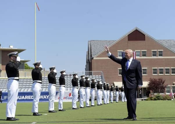 Donald Trump is saluted by students as he arrived at the US Coast Guard Academy in Connecticut, where he slammed the media. Picture: AP