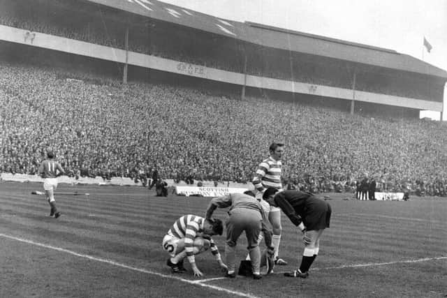 Saturday 26th April 1969 - the Old Firm Scottish Cup final between Celtic and Rangers in front of a Hampden crowd of 133,000. Celtic won 4-0. The trainer and referee attend to Celtic captain Billy McNeill after an unidentified injury. Picture: TSPL
