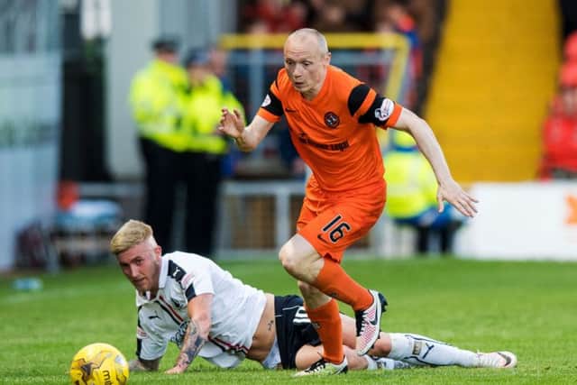 Dundee United midfielder Willo Flood, right, in action with Falkirk's Craig Sibbald in the first leg of the Premiership play-off semi-final. Picture: SNS
