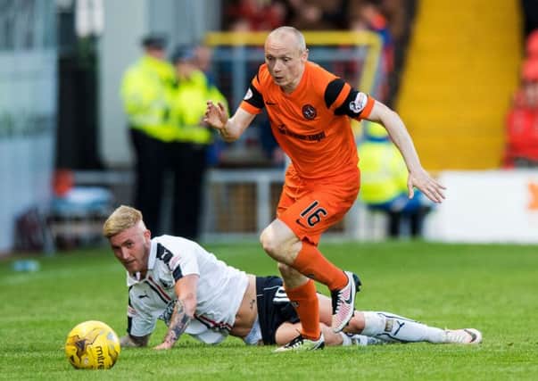 Dundee United midfielder Willo Flood, right, in action with Falkirk's Craig Sibbald in the first leg of the Premiership play-off semi-final. Picture: SNS