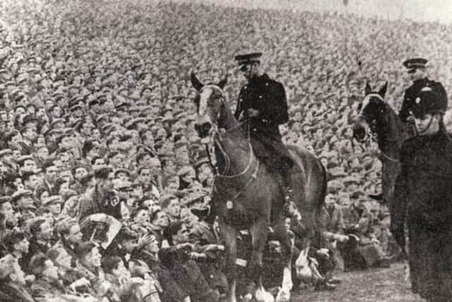 Mounted police keep an eye on the crowds at the Edinburgh derby in January 1950 at Easter Road. A record attendance of more than 65,000 fans saw Hearts beat Hibs by two goals to one. Picture: Evening News