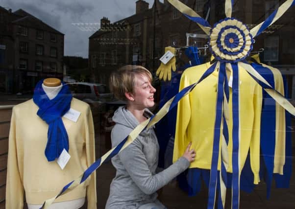 Would-be designer Rachel Connelly dresses a window in a shop on the High Street. Picture: John Devlin