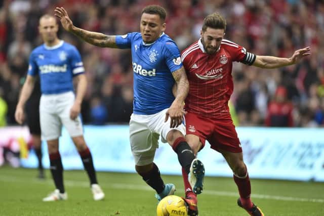 James Tavernier battles with Graeme Shinnie. Pic: SNS/Rob Casey