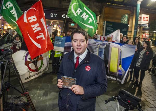 Scottish Labour transport spokesman Neil Bibby campaigning for rail nationalisation at Glasgow Central. Picture: John Devlin