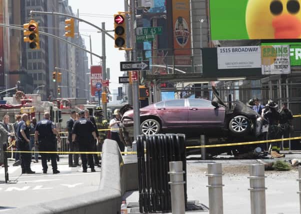 A car rests on a security barrier in New York's Times Square after driving through a crowd of pedestrians. Picture: AP