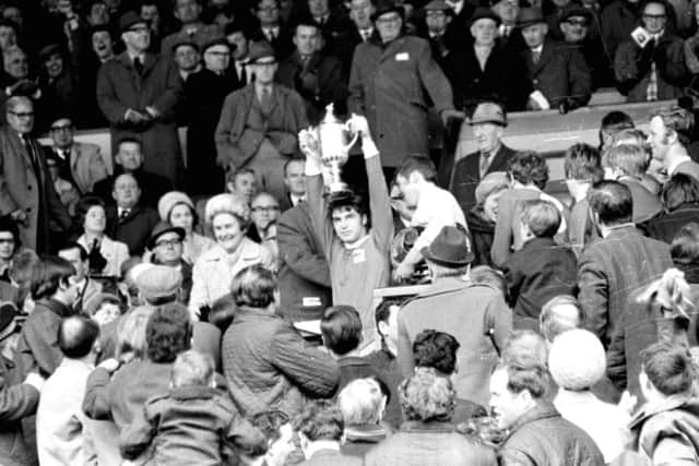 Martin Buchan, the only man to captain Scottish and FA Cup winners, lifts the trophy at Hampden in 1970. Photograph: Denis Straughan