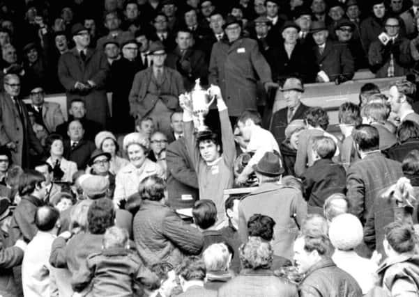 Martin Buchan, the only man to captain Scottish and FA Cup winners, lifts the trophy at Hampden in 1970. Photograph: Denis Straughan