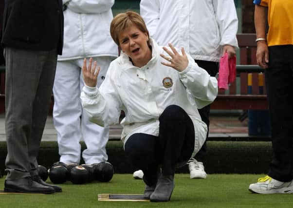 Nicola Sturgeon reacts after delivering a bowl during a campaign visit to Liberton Bowling Club in Edinburgh South yesterday. Picture: Andrew Milligan/PA