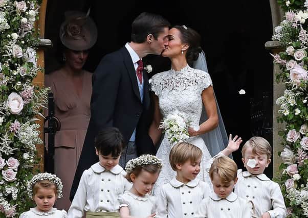 Pippa Middleton kisses her new husband James Matthews, following their wedding ceremony at St Mark's Church in Englefield, west of London. Picture: AFP/Getty Images