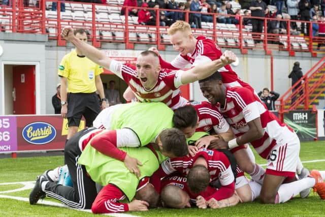 Hamilton's pile-on as they celebrate one of the goals which kept them up. Pic: SNS/Alan Harvey