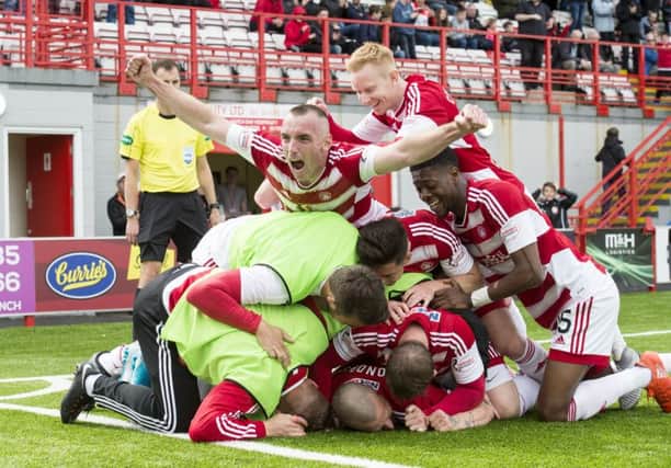 Hamilton's pile-on as they celebrate one of the goals which kept them up. Pic: SNS/Alan Harvey