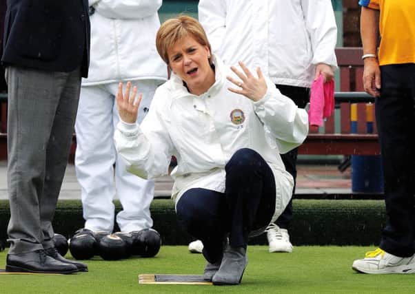 Nicola Sturgeon reacts after delivering a bowl during a campaign visit to Liberton Bowling Club in Edinburgh South. Picture: Andrew Milligan/PA