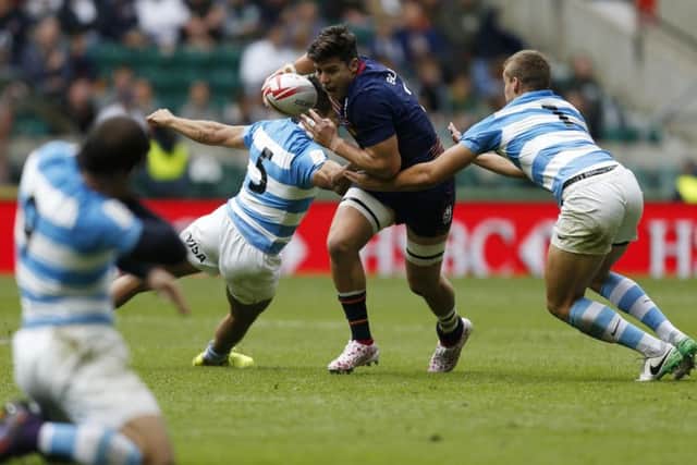 Hugh Blake tries to burst past Santiago Mare and Jose Barros Sosa in the 26-19 win over Argentina.  Photograph: Paul Harding/PA