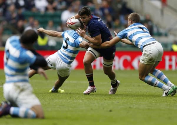Hugh Blake tries to burst past Santiago Mare and Jose Barros Sosa in the 26-19 win over Argentina.  Photograph: Paul Harding/PA