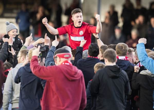 Brechin's Finn Graham celebrates with the fans at full time. Picture: Ross Parker