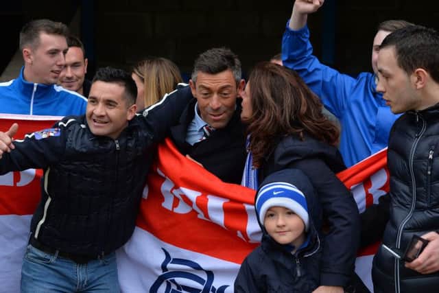 Rangers manager Pedro Caixinha is mobbed by fans after his side's 2-1 victory over St Johnstone. Picture: PA