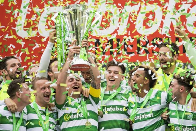 Celtic captain Scott Brown lifts the Ladbrokes Premiership trophy. Picture: SNS