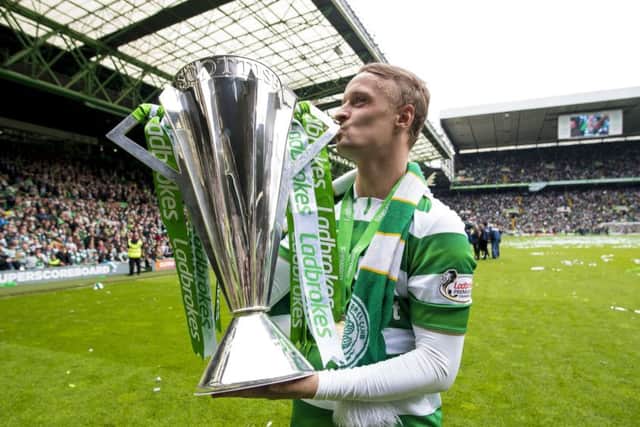 Leigh Griffiths celebrates with the Ladbrokes Premiership trophy following Celtic's win over Hearts. Picture: PA