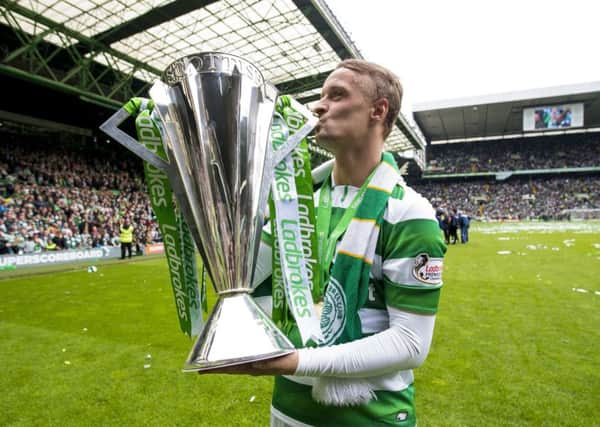 Leigh Griffiths celebrates with the Ladbrokes Premiership trophy following Celtic's win over Hearts. Picture: PA