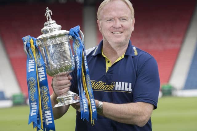 Alex McLeish, who lifted the Scottish Cup in 1990, gets his hands on the trophy again Picture: Steve Welsh.