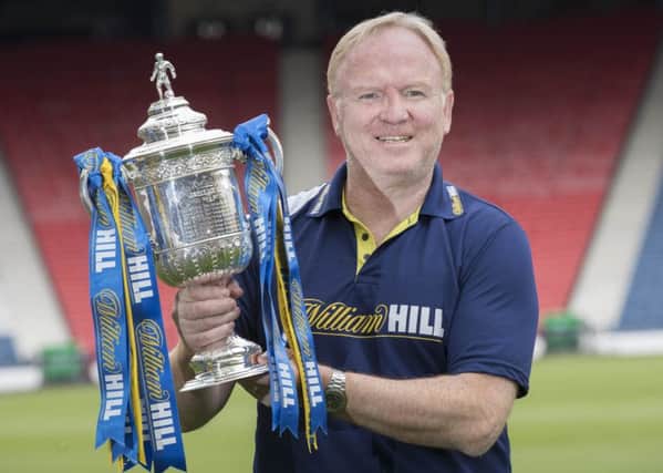 Alex McLeish, who lifted the Scottish Cup in 1990, gets his hands on the trophy again Picture: Steve Welsh.