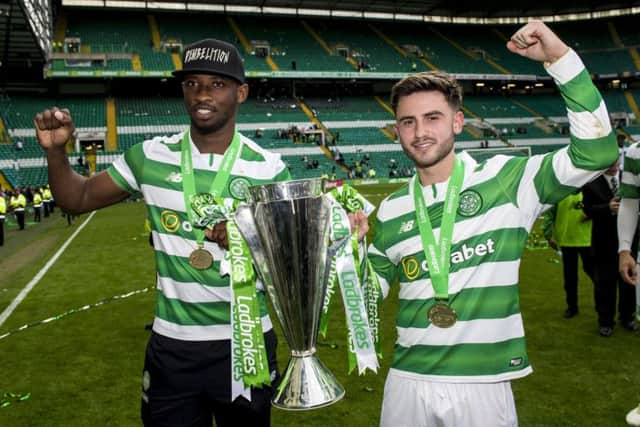 Patrick Roberts, right, and Moussa Dembele with the Premiership championship trophy. Picture: Craig Williamson/SNS