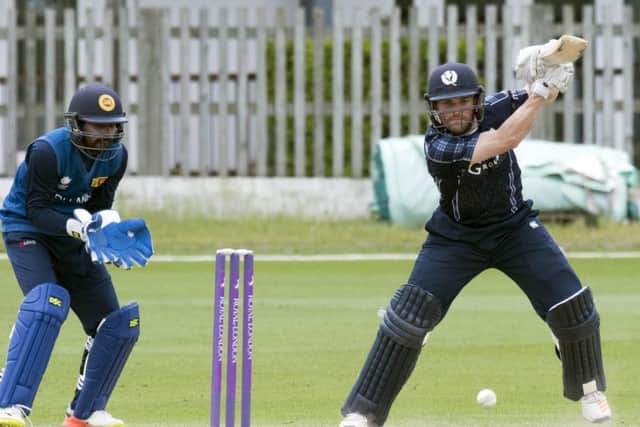 Craig Wallace, who top-scored for Scotland powers a drive as wicketkeeper Niroshan Dickwella looks on. Picture: Donald MacLeod