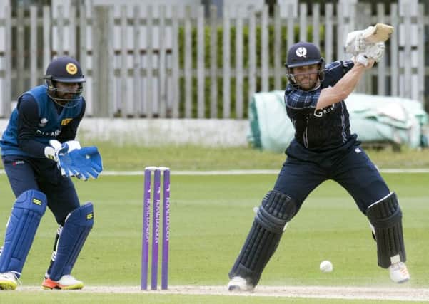 Craig Wallace, who top-scored for Scotland powers a drive as wicketkeeper Niroshan Dickwella looks on. Picture: Donald MacLeod