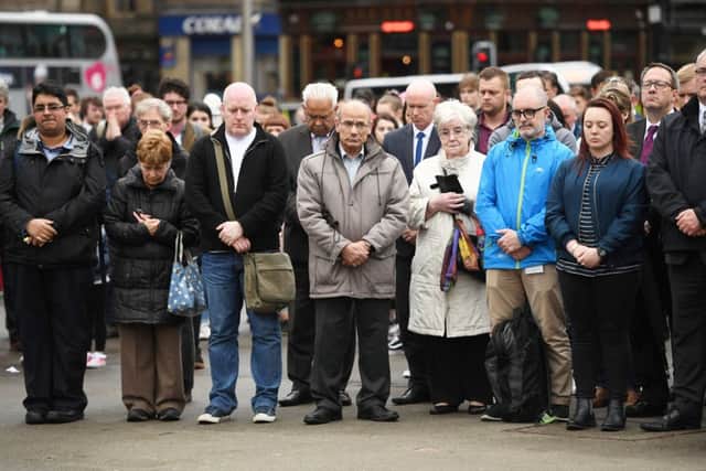 Crowds in George Square pay their respects. Picture: SWNS