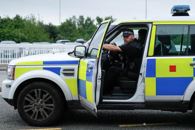 Armed police officers in a car at Manchester Airport today. Picture: SWNS
