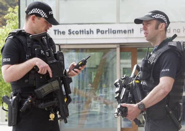 Armed Police outside The Scottish Parliament in Edinburgh. Picture: SWNS