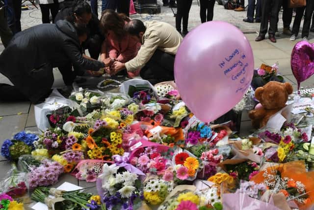 Ballons and flowers are seen in Albert Square in central Manchester. Picture: Getty
