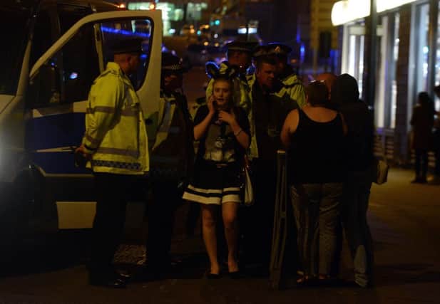 A number of concert-goers are led to safety after the Manchester Arena bombing. Pic: SWNS