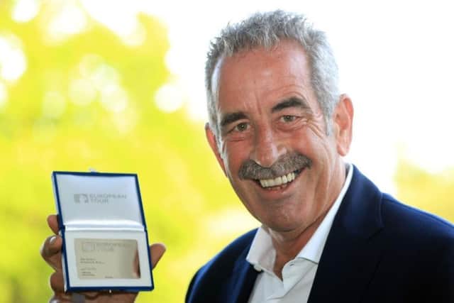 Sam Torrance shows off his commemorative card after being honoured by the European Tour.