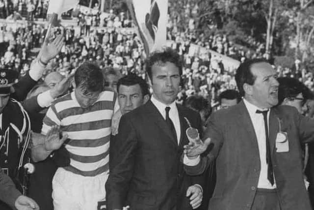 The Scotsman's John Rafferty and journalist colleague Hugh McIlvanney lead Billy McNeill through the crowds to the trophy presentation.