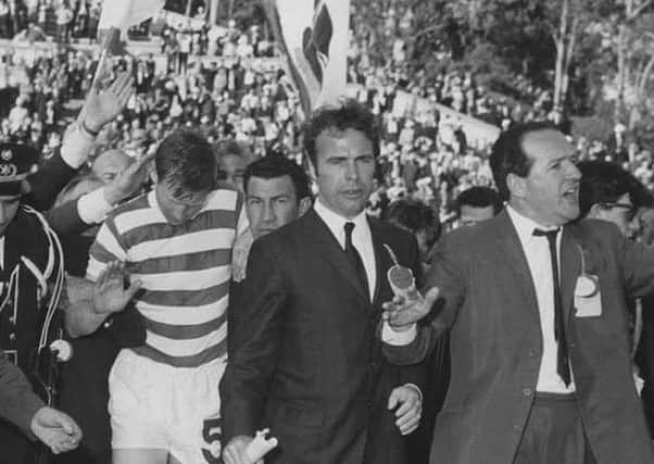 The Scotsman's John Rafferty and journalist colleague Hugh McIlvanney lead Billy McNeill through the crowds to the trophy presentation.