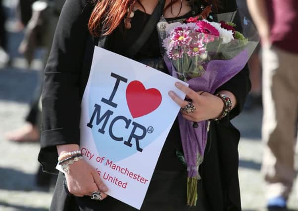 People gathered for a vigil in Manchester's Albert Square on Tuesday evening. Picture: PA
