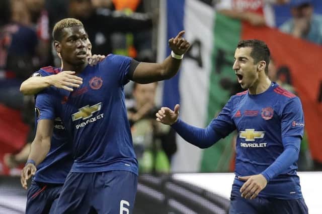 Man United's Paul Pogba celebrates with team-mates Matteo Darmian and Henrikh Mkhitaryan, right, after opening the scoring in the Europa League final. Picture Michael Sohn/AP